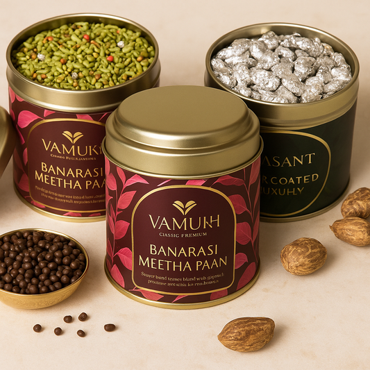 Premium VAMUKH gifting tins – Banarasi Meetha Paan, Chocolate Saunf, and Silver-Coated Mukhwas arranged elegantly on beige stone with brass accents.