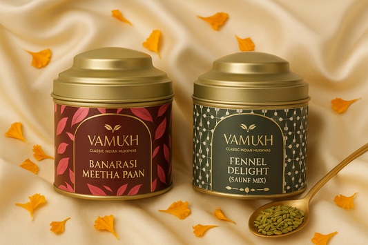 Royal Refresh Set – Banarasi Meetha Paan and Fennel Delight tins styled on cream silk with marigold petals and brass fennel spoon.
